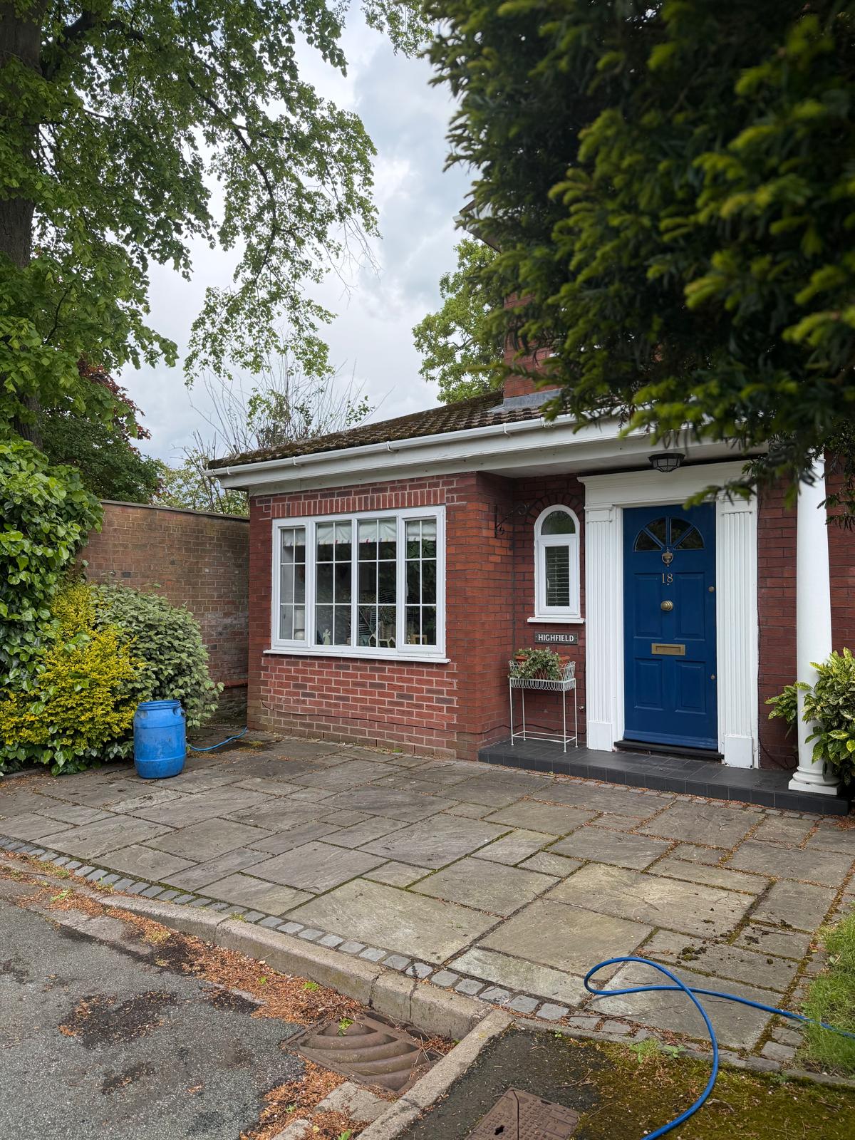 Indian stone driveway before cleaning - moss and discolouration visible on slabs