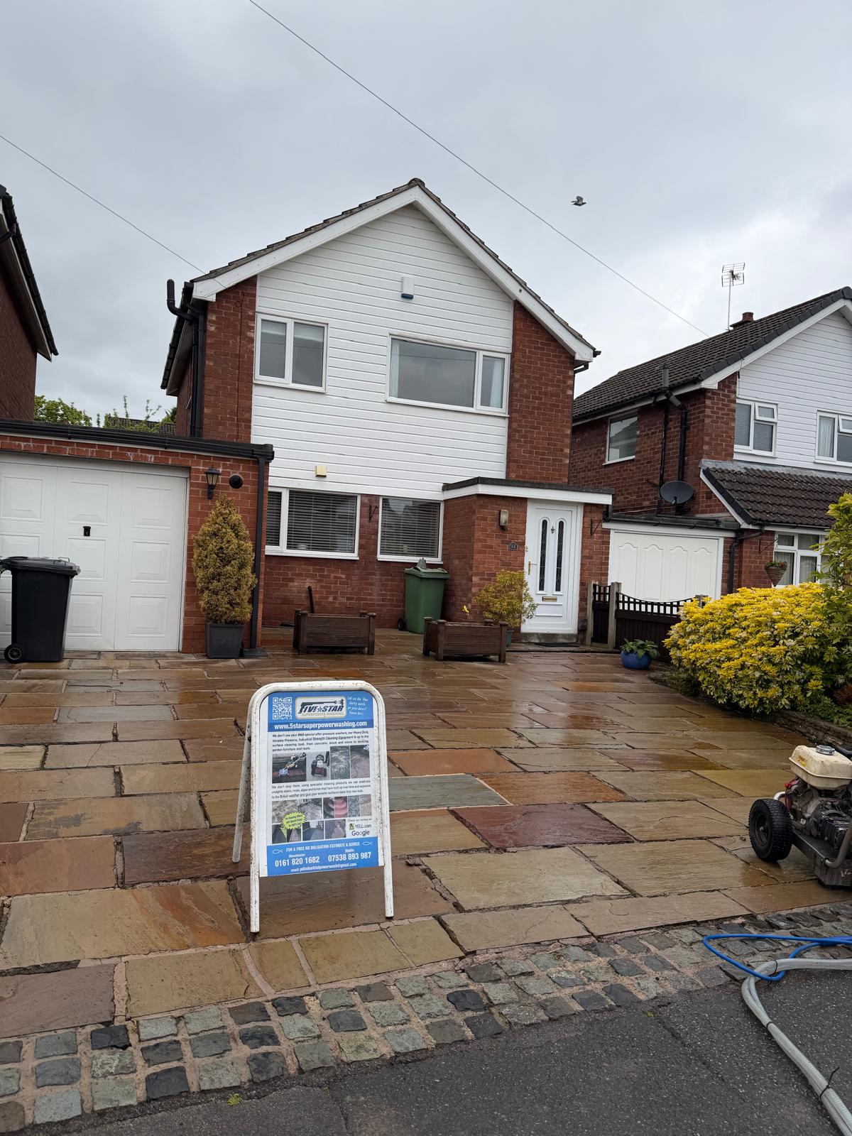 Flagstone driveway after pressure washing - natural stone colour fully restored