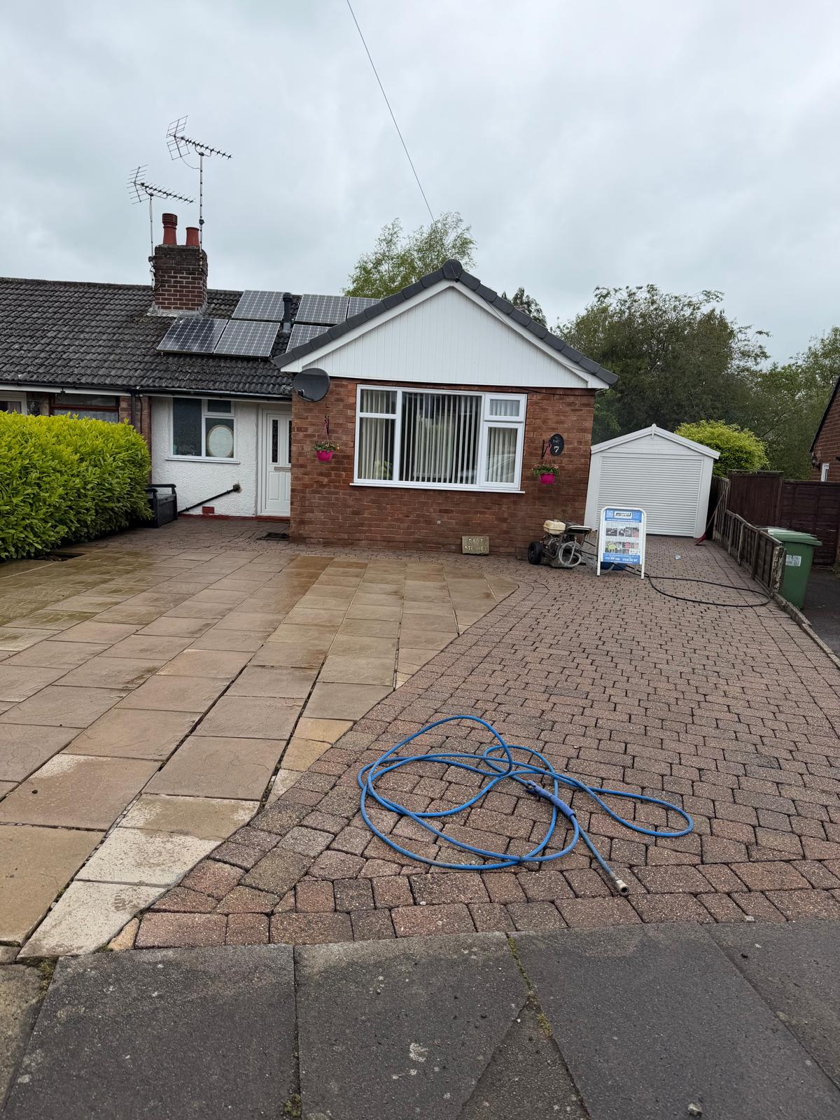 Bungalow driveway after pressure washing - clean flagstones and block paving