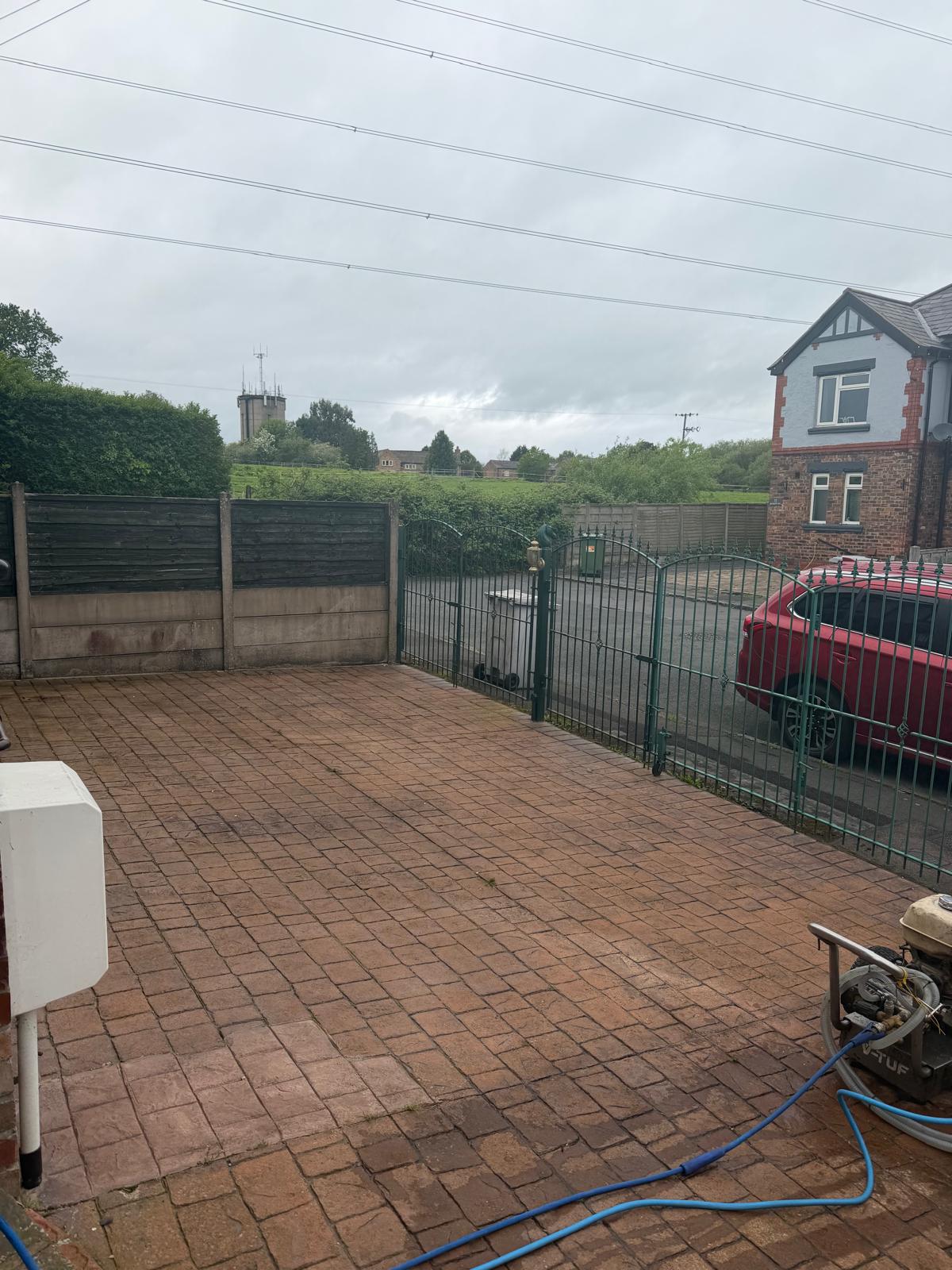 Stamped concrete driveway before cleaning - dirt and grime covering the pattern