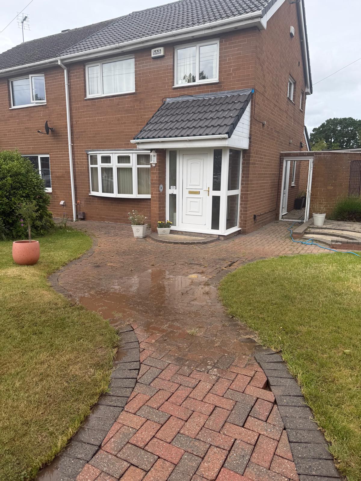 Block paving path and driveway before cleaning - dark staining and moss build-up