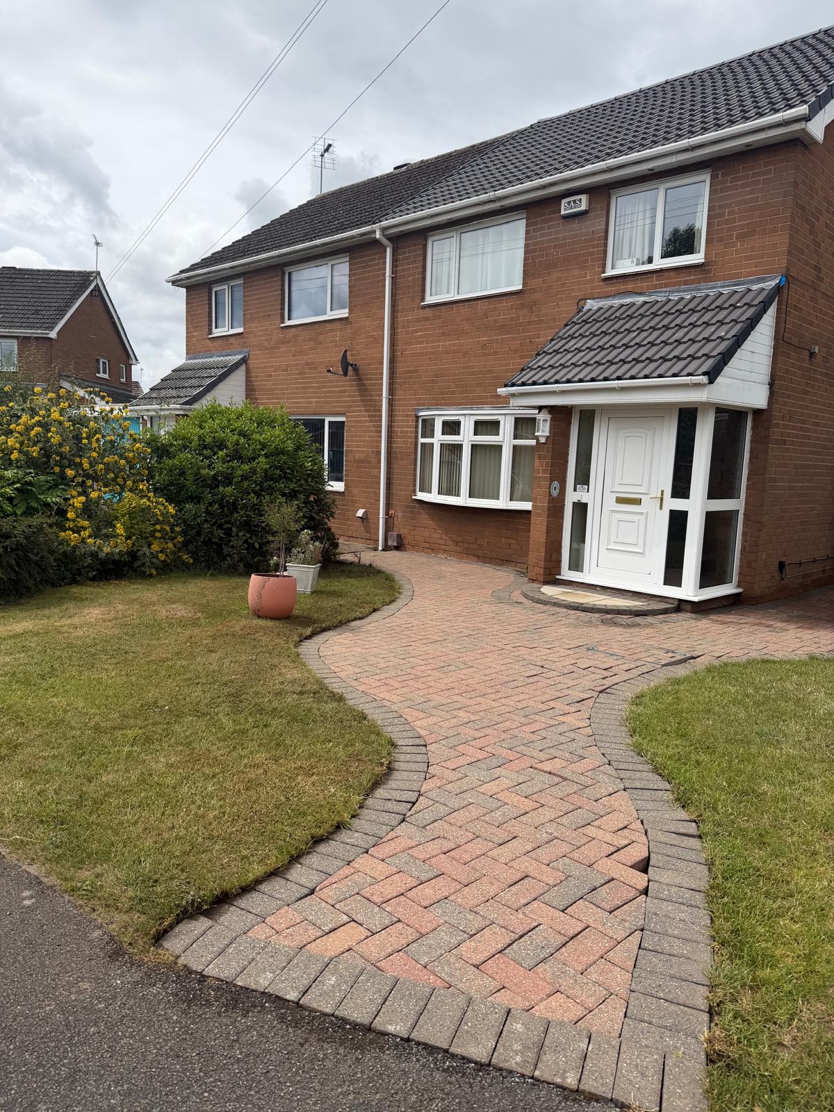 Block paving path and driveway after cleaning - herringbone pattern colour restored